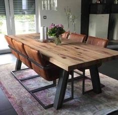 a wooden table sitting in the middle of a living room