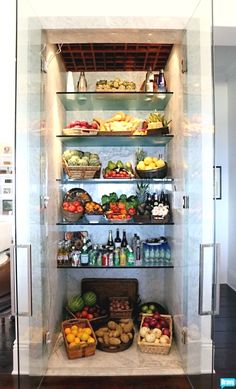 an open refrigerator filled with lots of fresh fruits and veggies on it's shelves