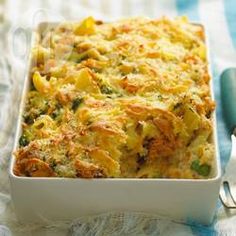 a casserole dish with broccoli and cheese in it on a table