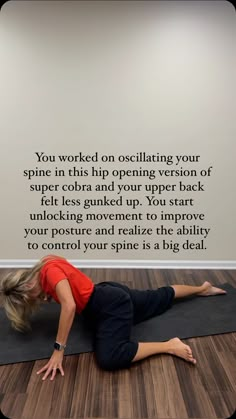 a woman is doing yoga on the floor in front of a wall with an inspirational quote