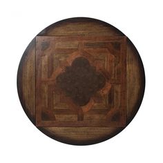 a round wooden table with an intricate design