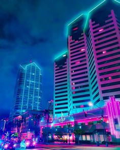 some very tall buildings with neon lights on them