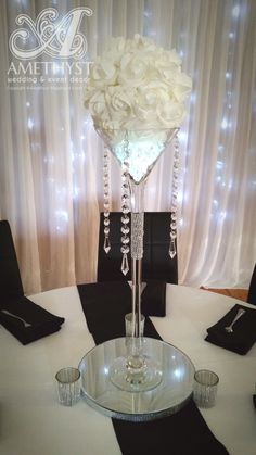 a centerpiece with flowers in it on top of a table