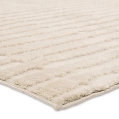 a large white rug with wavy lines on the top and bottom, is shown in front of a white background