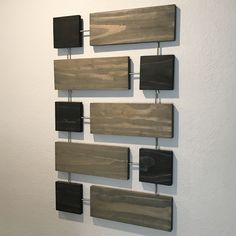 several pieces of wood are hanging on the wall