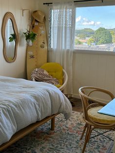 a bedroom with a surfboard on the wall