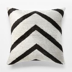 black and white chevroned pillow on a white background with an arrow pattern in the middle