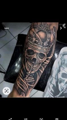 a man's arm with a skull and crown tattoo on it