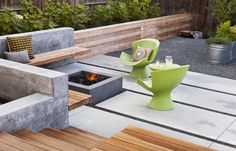 an outdoor fire pit surrounded by wooden benches