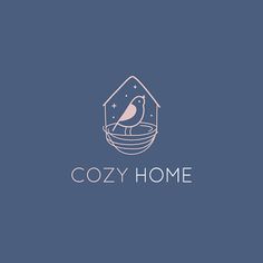 the logo for cozy home with a bird sitting in a bowl on top of it