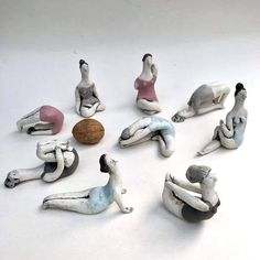 there are many figurines sitting on the floor with one laying down and another standing up