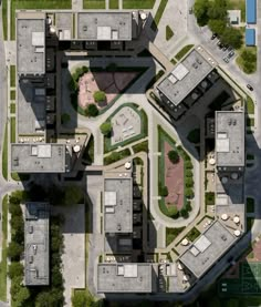 an aerial view of some buildings and parking spaces in the middle of a city street