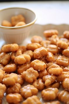 some food is sitting on a plate and next to a small bowl with something in it