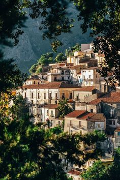 an old village is nestled on the side of a mountain