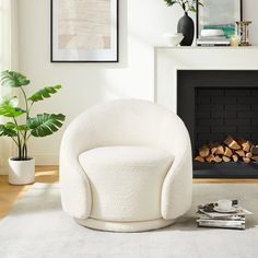 a white chair sitting in front of a fire place next to a potted plant