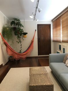 a living room with a hammock hanging from the ceiling