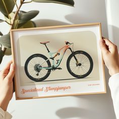 a person holding up a framed photo with a bike on the front and back side