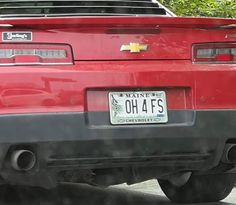 the back end of a red car with a license plate