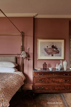 a bed sitting next to a wooden dresser under a painting on the wall in a bedroom