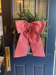 a red and white gingham bow on the front door