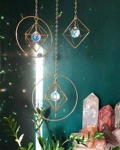 two metal circles hanging from chains next to crystals