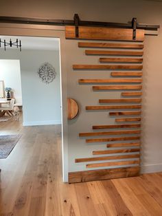 a room with wood flooring and a wooden wall mounted to the side of it