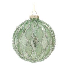 a green glass ornament hanging from a gold chain on a white background photo