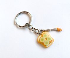 a key chain with a piece of fruit on it