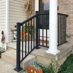 the front porch is decorated for halloween with pumpkins