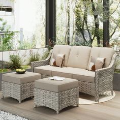 an outdoor living room with wicker furniture