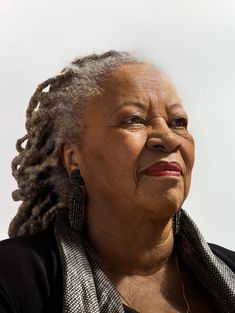 Portrait lumineux de Toni Morrison, souriante, portant des dreadlocks grises, des boucles d'oreilles noires et un foulard à motifs, capturant sa grâce et sa présence charismatique Silver Locs, Black Grandma, Grandma Black, Cool Grandma, Toni Morrison, Women Writers