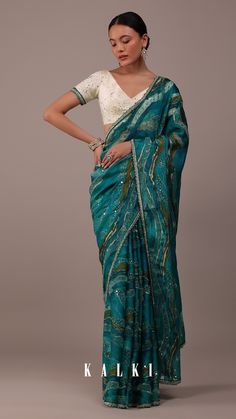 Bringing to you Kalki's classic crepe saree collection, straight from the heart of Kalki fashion. Our viridian green saree in crepe. The saree is fabricated in crepe in a stunning design. The saree has a sequin and cut-dana embroidered border. It comes with a matching unstitched blouse. Sari India