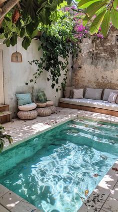 an outdoor swimming pool surrounded by greenery