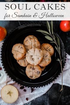 some cookies are on a black plate with apples in the background and text overlay reads soul cakes for samhau & halloween