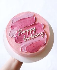 a pink birthday cake with the words happy birthday written on it