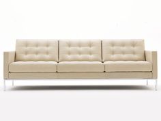 a white couch sitting on top of a white floor