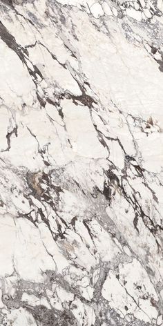 a white and brown marble counter top with black veining on the edges, in an angled view