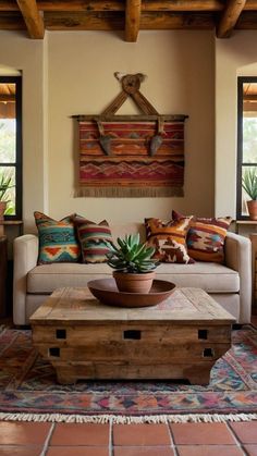 a living room filled with furniture and lots of pillows on top of a wooden table