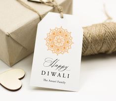 a tag that says happy diwali next to some twine and a heart