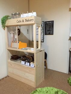 a small display case in the corner of a room with green carpet on the floor