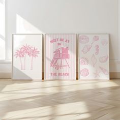 three pink and white prints are on the floor in an empty room with wood floors