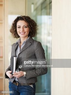 a woman holding a binder and smiling at the camera