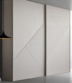 a white cabinet sitting next to a wall with a light on it's side