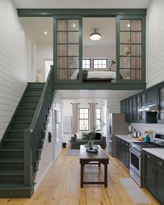 an open floor plan with stairs leading up to the loft