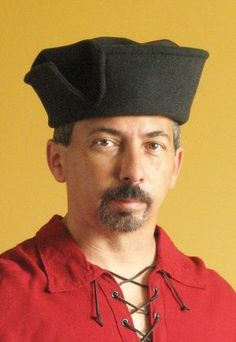 a man in a red shirt with a black hat on his head