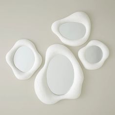 three white oval mirrors sitting next to each other