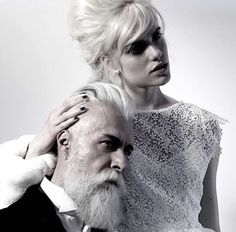 a man and woman with white hair are posing for a black and white photo together