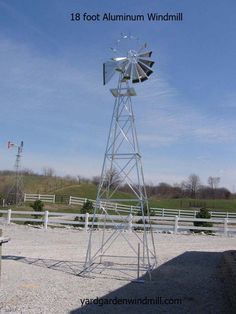 a windmill sitting in the middle of a field