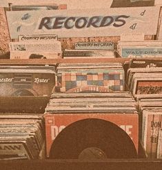 there are many records on display in the store and one has a record player next to it