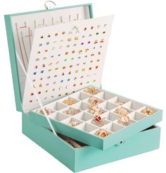 an open jewelry box filled with lots of rings